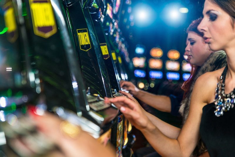Women gambling at slot machines