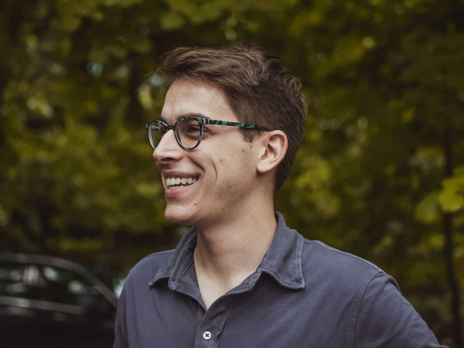 Testimonials - photo of caucasuain man smiling with trees behind him